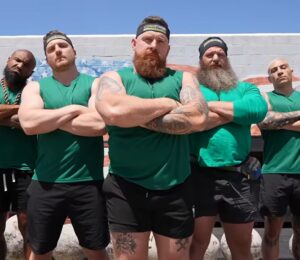 The vegan team stands with arms crossed before competing in a vegans vs meat eaters strength challenge organized by fitness YouTuber Brandon William