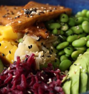 Close-up of the high-protein vegan poke bowl containing edamame, avocado, glazed tofu, and more