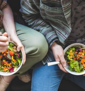 Photo shows a couple eating salad out of a bowl. Could adopting a plant-based or plant-rich diet make you more attractive? A new narrative review has found that eating less meat and more plants can change how you look, smell, and feel, and benefit your overall health.