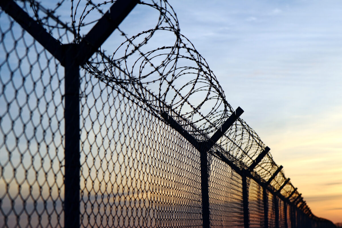 Photo shows a barbed wire-topped fence. The European Court of Human Rights (ECHR) has found that Switzerland violated two vegan prisoners’ “freedom of conscience” when it failed to provide them with meals consistent with their ethical beliefs