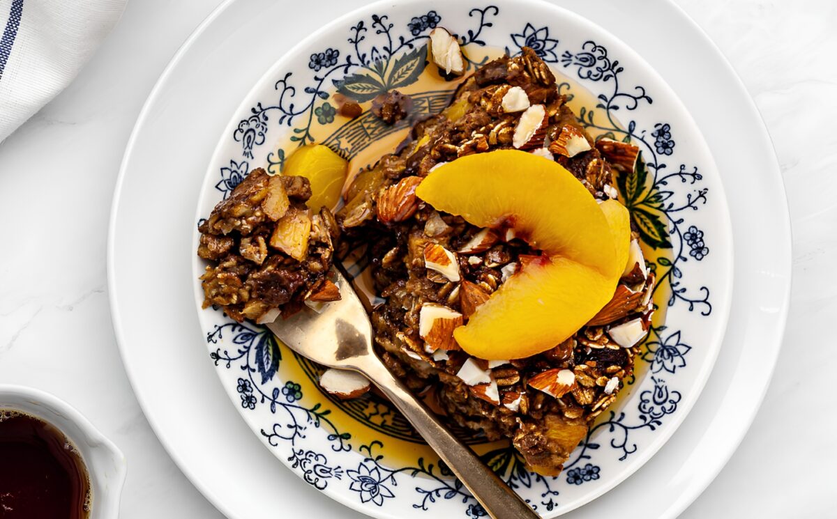 Ginger Peach Baked Oatmeal with rolled oats, frozen peaches, raisins, and almonds