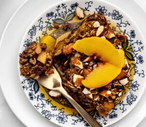 Ginger Peach Baked Oatmeal with rolled oats, frozen peaches, raisins, and almonds
