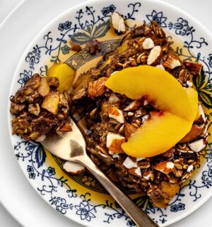Ginger Peach Baked Oatmeal with rolled oats, frozen peaches, raisins, and almonds