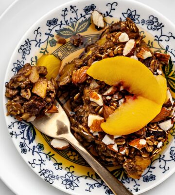 Ginger Peach Baked Oatmeal with rolled oats, frozen peaches, raisins, and almonds
