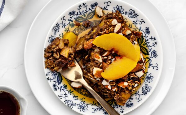 Ginger Peach Baked Oatmeal with rolled oats, frozen peaches, raisins, and almonds