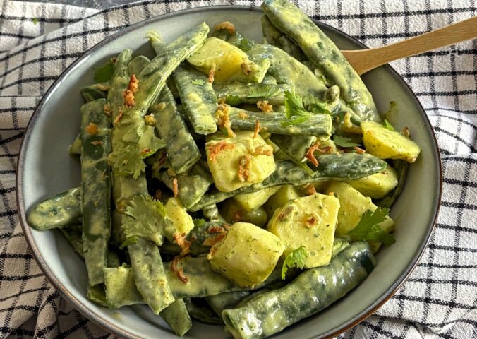 Herby Runner Bean And Potato Salad with dressing served with capers, coriander, and crispy onions