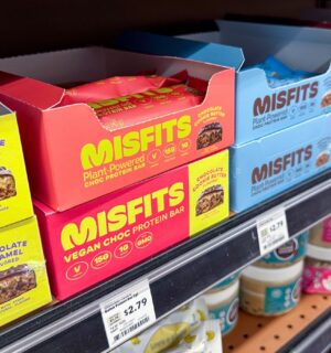 Photo shows boxes of Misfits protein bars on a shelf in the US, many of which use the phrase "plant-powered." Misfits Health has announced a new protein bar made with dairy chocolate, whey powder, and bovine collagen, and its vegan customers are not happy