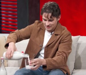 Photo shows 'Obsession' actor Michael Johnston during a recent appearance on 'Access Hollywood,' pouring a glass of plant-based almond milk that he made himself