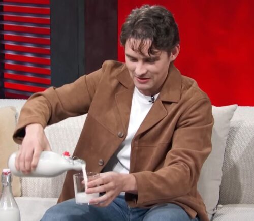 Photo shows 'Obsession' actor Michael Johnston during a recent appearance on 'Access Hollywood,' pouring a glass of plant-based almond milk that he made himself