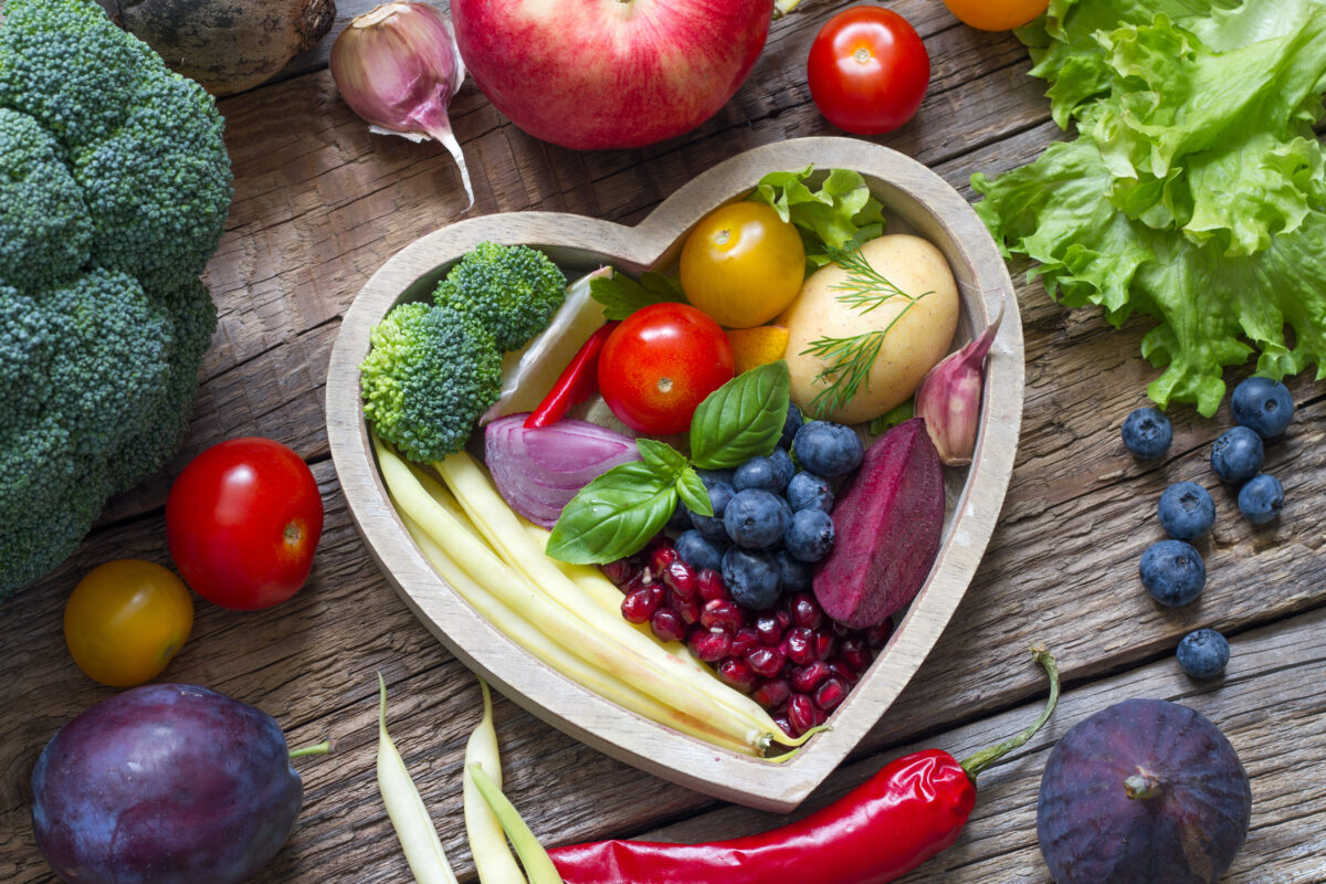 Photo shows a selection of brightly colored fruits and vegetables arranged in a heart shape. A new study has found that following the plant-rich Planetary Health Diet can cut heart disease risk by up to 28 percent