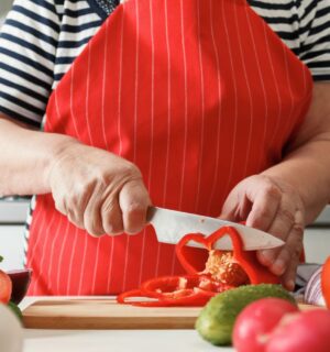 Photo shows an older woman preparing fresh vegetables in her kitchen at home. A new study has found that following the plant-rich Planetary Health Diet can cut heart disease risk by up to 28 percent