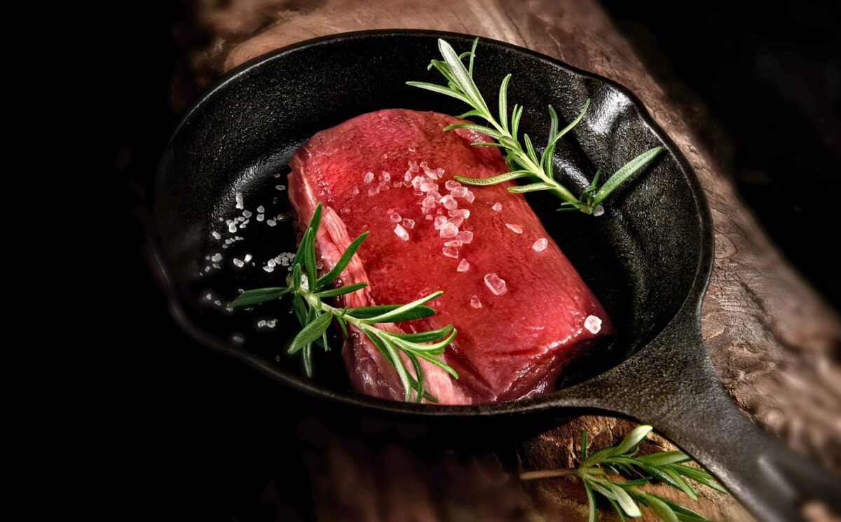 Photo shows a rare steak in a cast iron pan with rosemary and salt. Cultivated protein startup MyriaMeat has made a venison breakthrough with roe deer stem cells