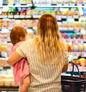 Photo shows a mother holding a baby and grocery store shopping. Over 80 percent of food for toddlers sold at US grocery stores in Austin, Texas is ultra-processed, according to a new audit