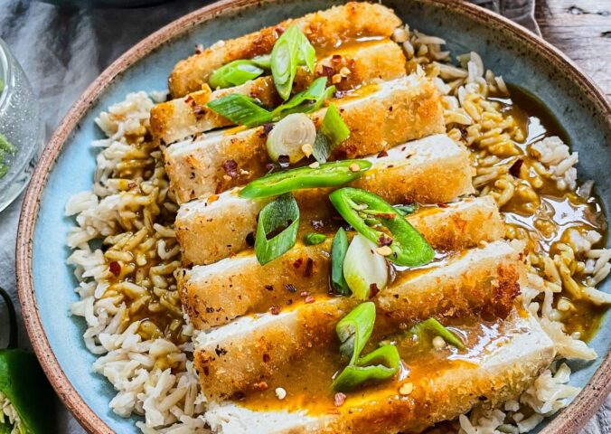 tofu katsu curry with brown rice, carrot and onion curry, and a panko-covered piece of tofu for plant-based meals that keep you full