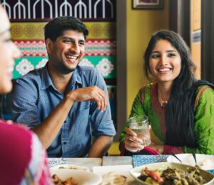 Photo shows an Indian couple eating with friends at a cafe or restaurant. New research has found that nearly 60 percent of young Indians are already “meat-reducers,” while 50 percent of those who self-identify as omnivores are open to the idea of veganism.