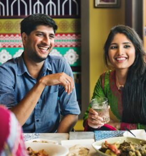 Photo shows an Indian couple eating with friends at a cafe or restaurant. New research has found that nearly 60 percent of young Indians are already “meat-reducers,” while 50 percent of those who self-identify as omnivores are open to the idea of veganism.