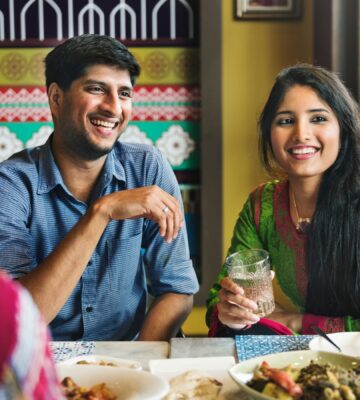 Photo shows an Indian couple eating with friends at a cafe or restaurant. New research has found that nearly 60 percent of young Indians are already “meat-reducers,” while 50 percent of those who self-identify as omnivores are open to the idea of veganism.