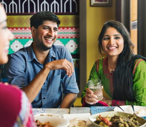 Photo shows an Indian couple eating with friends at a cafe or restaurant. New research has found that nearly 60 percent of young Indians are already “meat-reducers,” while 50 percent of those who self-identify as omnivores are open to the idea of veganism.