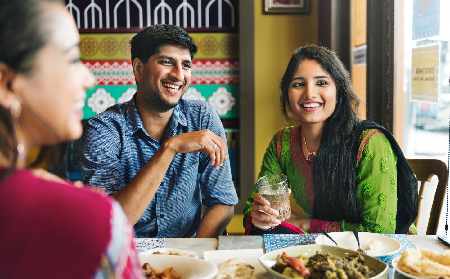 Photo shows an Indian couple eating with friends at a cafe or restaurant. New research has found that nearly 60 percent of young Indians are already “meat-reducers,” while 50 percent of those who self-identify as omnivores are open to the idea of veganism.