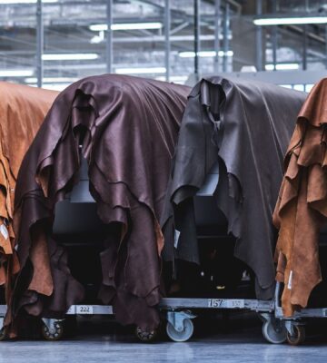 Photo shows layers of animal hides draped in a factory setting. Animal leather emits over 1,100 percent more emissions than vegan leather, according to a new study