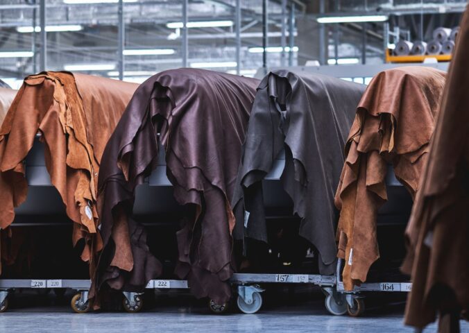 Photo shows layers of animal hides draped in a factory setting. Animal leather emits over 1,100 percent more emissions than vegan leather, according to a new study