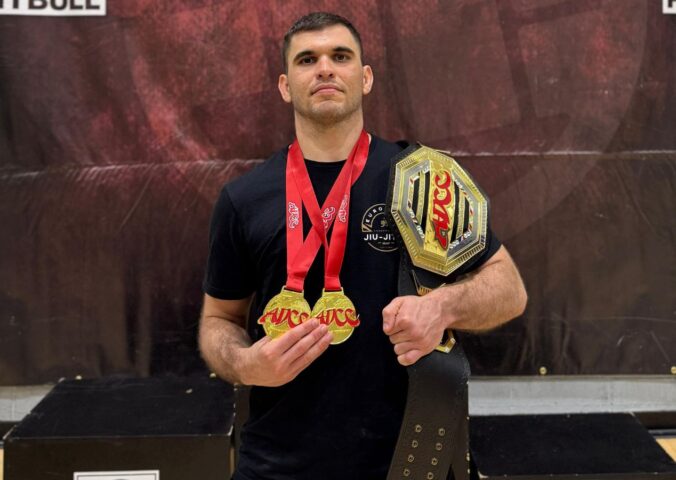 Photo shows Bernardo Ficarella, a vegan athlete and champion martial artist with black belts in both judo and Brazilian jiu-jitsu, wearing multiple medals and holding a trophy