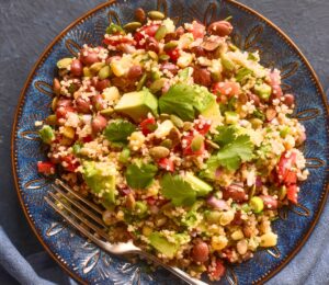Kaleidoscopic Quinoa Salad with peppers, avocado, roasted seeds, beans and more