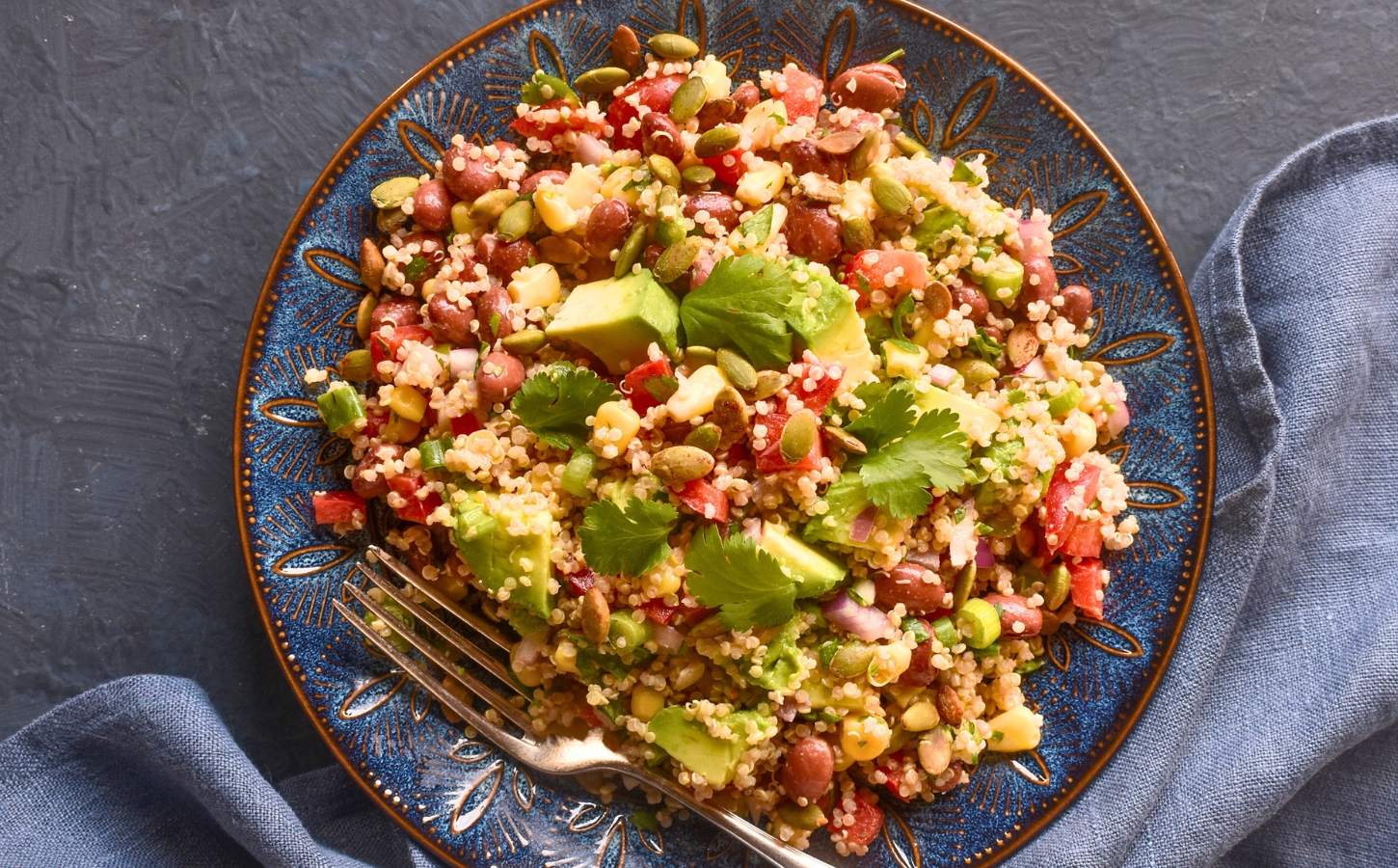 Kaleidoscopic Quinoa Salad with peppers, avocado, roasted seeds, beans and more