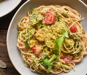Pasta With Arugula In A Creamy Lemon Sauce with cashews, whole-grain pasta, broccoli, tomato, and vegan parm