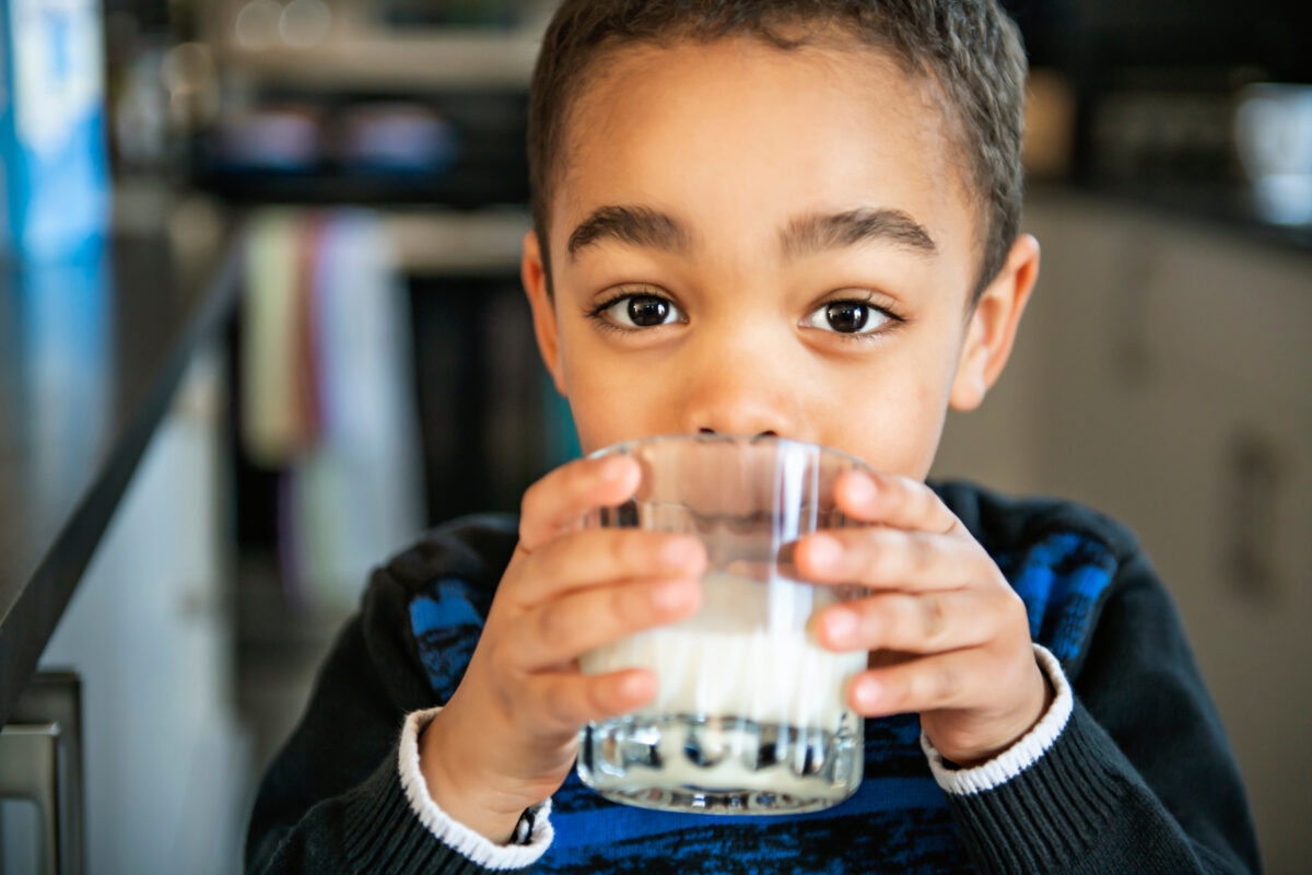 Photo shows a young boy drinking milk out of a glass. Shoppers can now purchase kid-friendly soy and oat milk products at Sainsbury’s, which are suitable for children one year old and up