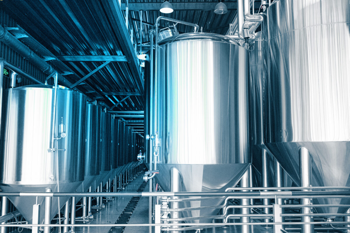 Photo shows large brewing vats. A number of researchers and companies are working on producing animal identical proteins for plant-based meat using microbial engineering, which could use the plant-grown myoglobin discovered by the team of scientists