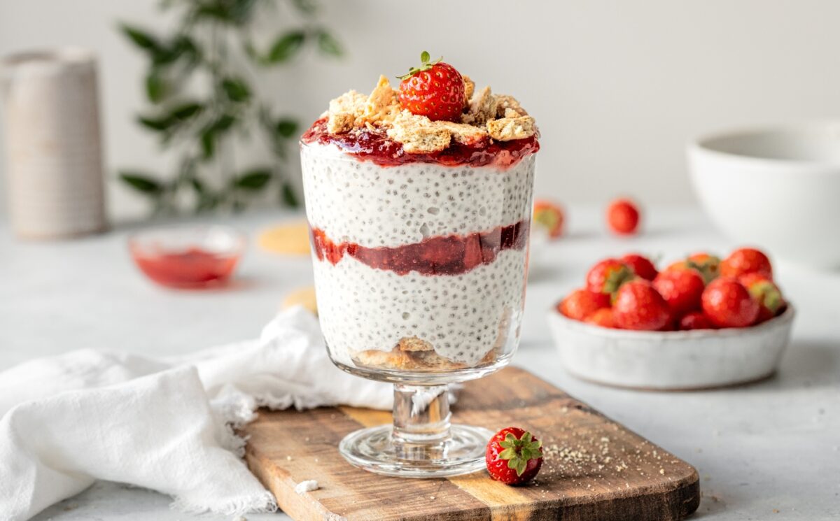 Strawberry Cheesecake Chia Pudding with coconut milk, cashews, vanilla, digestives, and strawberry compote for late summer vegan breakfasts