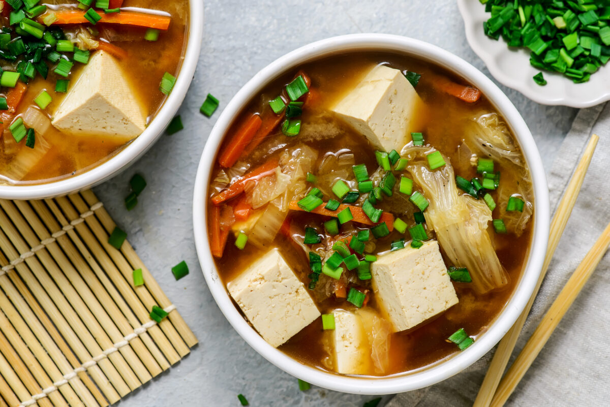Photo shows a bowl of soup made with tofu and noodles. According to a scientist’s new scoring system, tofu is the single best protein for nutrition, sustainability, and affordability