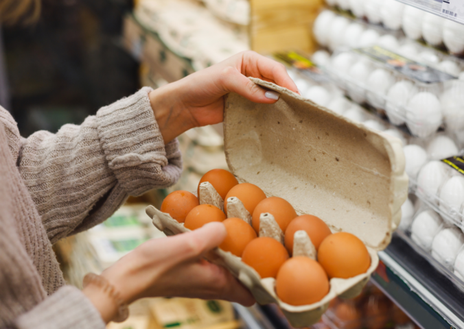 Photo shows a woman holding a carton of eggs in a supermarket. The UK Health Security Agency (UKHSA) has declared a national salmonella outbreak after one person died and hundreds became ill
