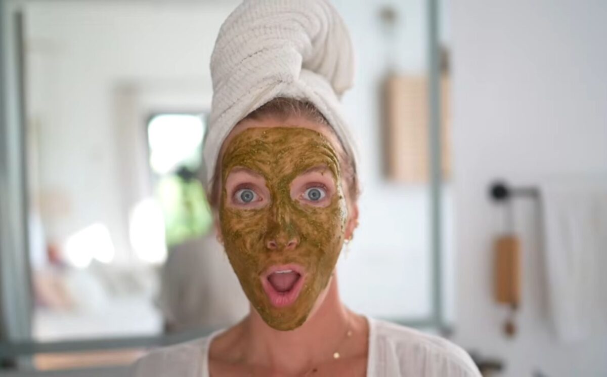 Image of Stanczyk with her hair wrapped in a white towel and her face covered in her matcha glow mask to illustrate article about DIY Plant-based spa treatments.