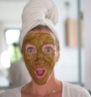 Image of Stanczyk with her hair wrapped in a white towel and her face covered in her matcha glow mask to illustrate article about DIY Plant-based spa treatments.