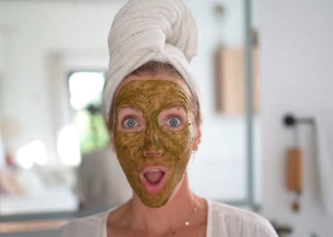 Image of Stanczyk with her hair wrapped in a white towel and her face covered in her matcha glow mask to illustrate article about DIY Plant-based spa treatments.