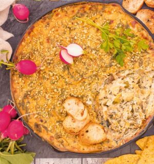 Baked Spinach And Artichoke Dip with tofu, garlic, vegan cream cheese, and brazil nut parm