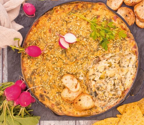 Baked Spinach And Artichoke Dip with tofu, garlic, vegan cream cheese, and brazil nut parm