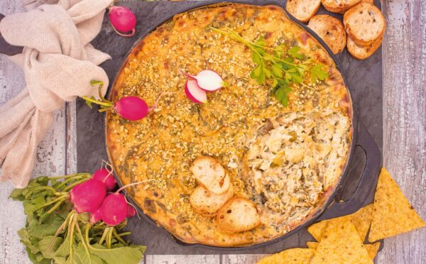 Baked Spinach And Artichoke Dip with tofu, garlic, vegan cream cheese, and brazil nut parm