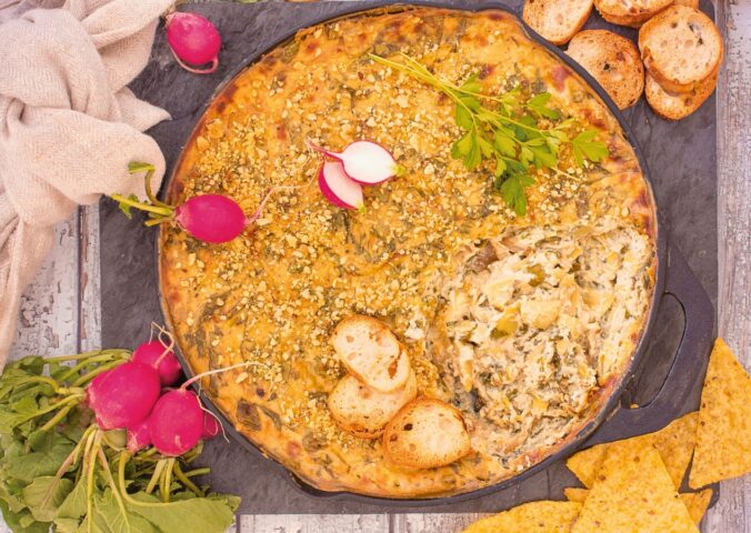 Baked Spinach And Artichoke Dip with tofu, garlic, vegan cream cheese, and brazil nut parm