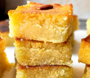 Basbousa (Semolina Cake) with floral simple syrup and almonds
