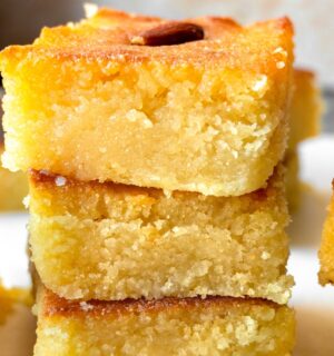 Basbousa (Semolina Cake) with floral simple syrup and almonds