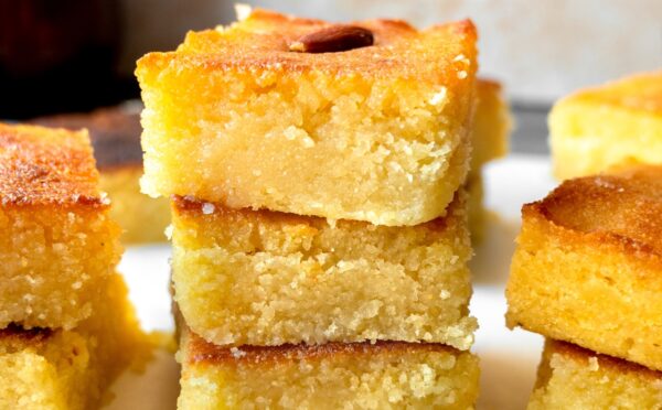 Basbousa (Semolina Cake) with floral simple syrup and almonds