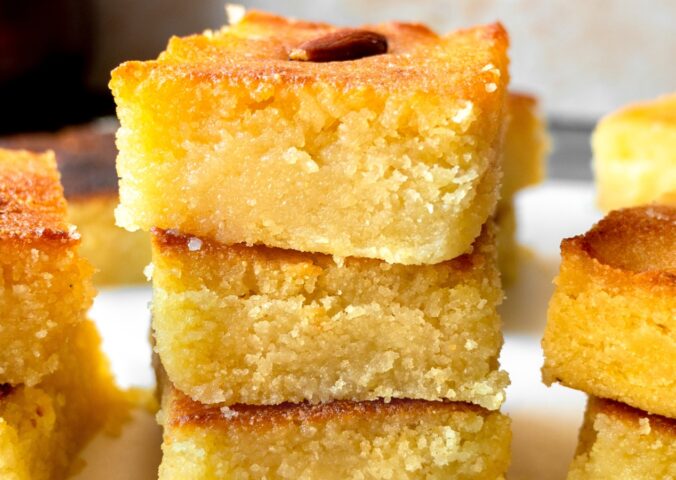 Basbousa (Semolina Cake) with floral simple syrup and almonds