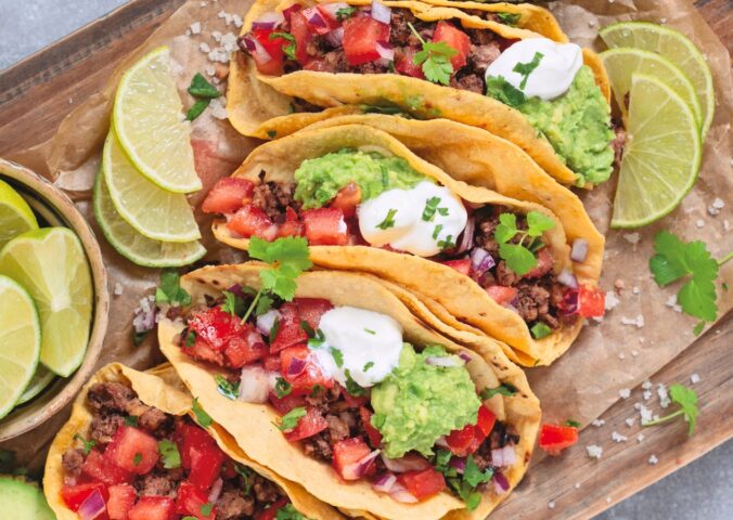 black bean and walnut tacos with salsa, avocado, lime, and sour cream