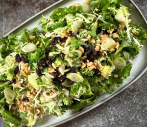 broccoli salad with kale, cabbage, dried cranberries, and peanuts