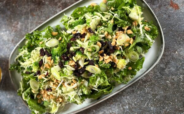 broccoli salad with kale, cabbage, dried cranberries, and peanuts