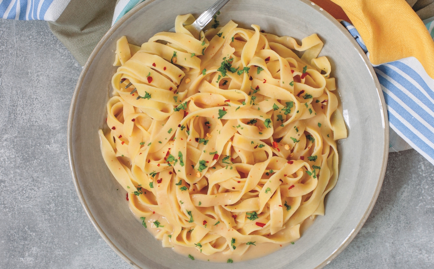 Creamy Cannellini Fettuccine Alfredo with nutritional yeast, onion, and lemon
