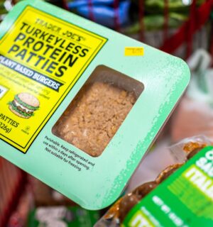 Photo shows someone's hand as they hold a pack of "Turkeyless Protein Patties" from Trader Joe's. Several members of the European Parliament (MEPs) have sought to expand the EU plant-based label ban to include more words